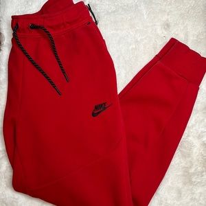 Nike tech sweat pants in the color red